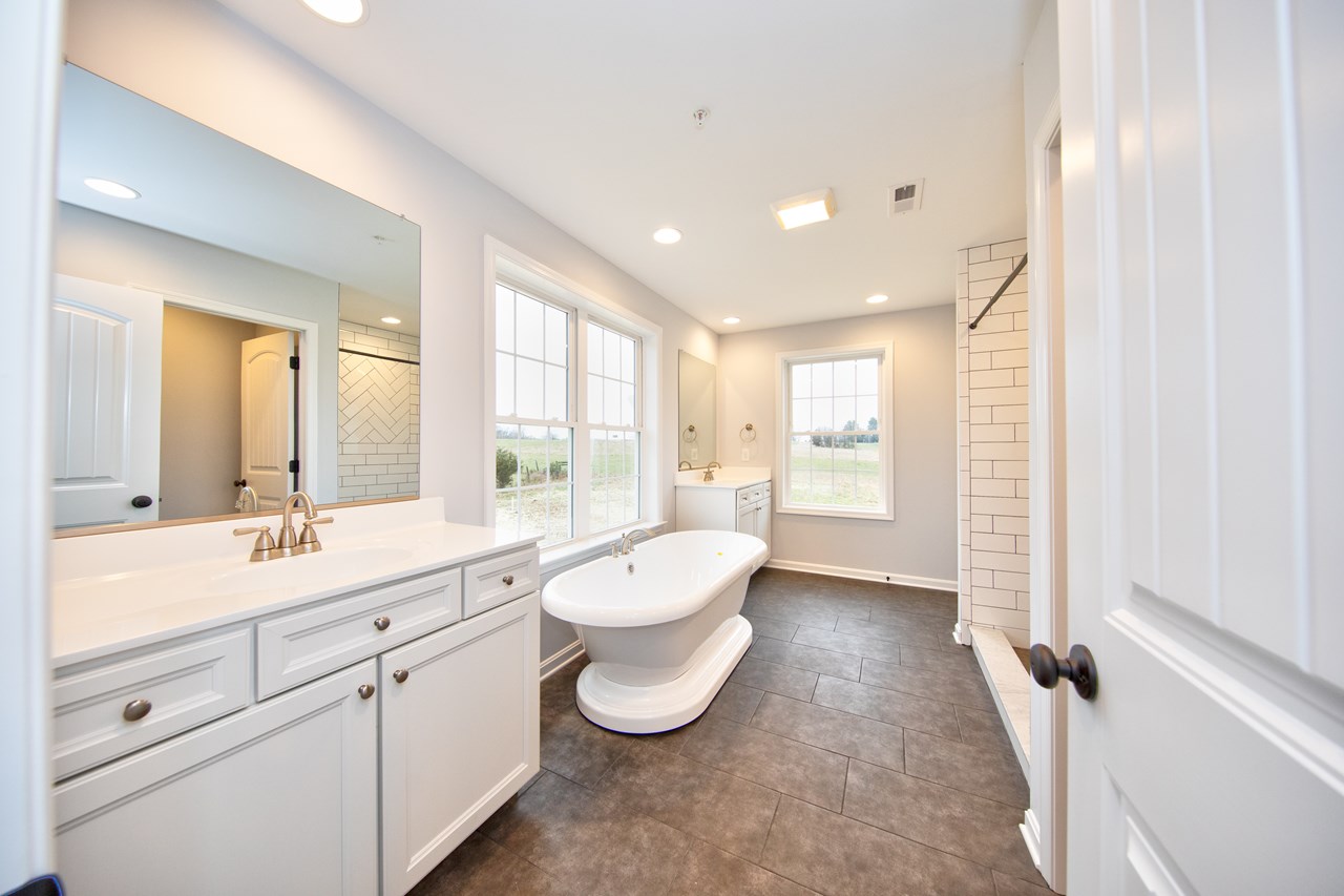 primary bathroom with double vanity, soaking tub & shower