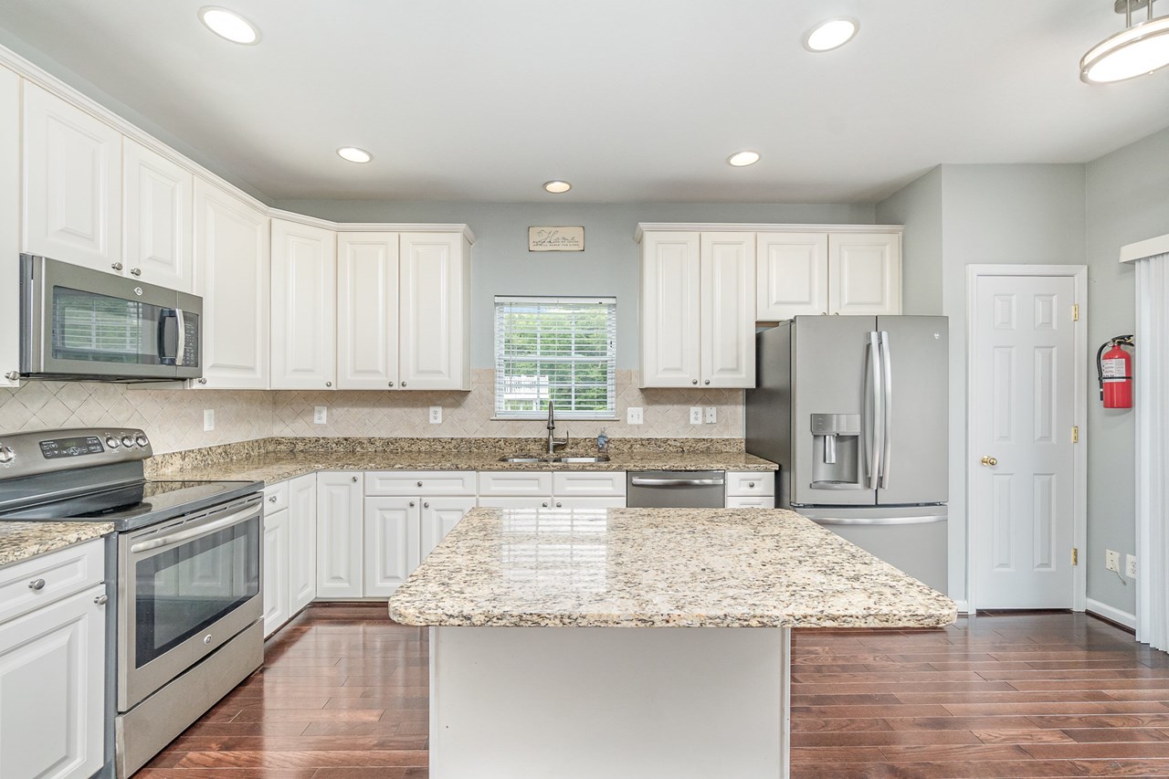 kitchen with pantry, granite counter tops & breakfast bar