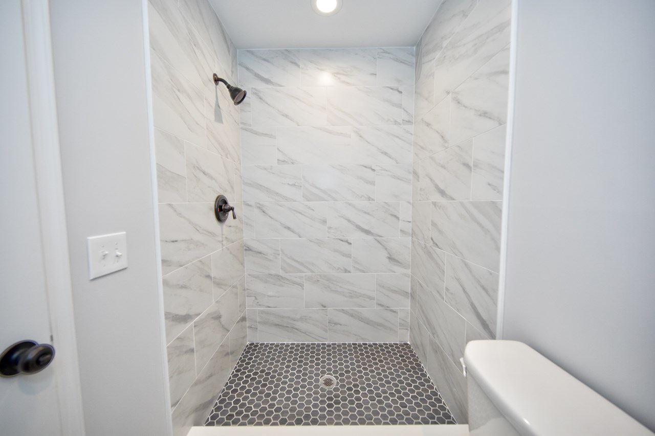 tiled shower in full bath
