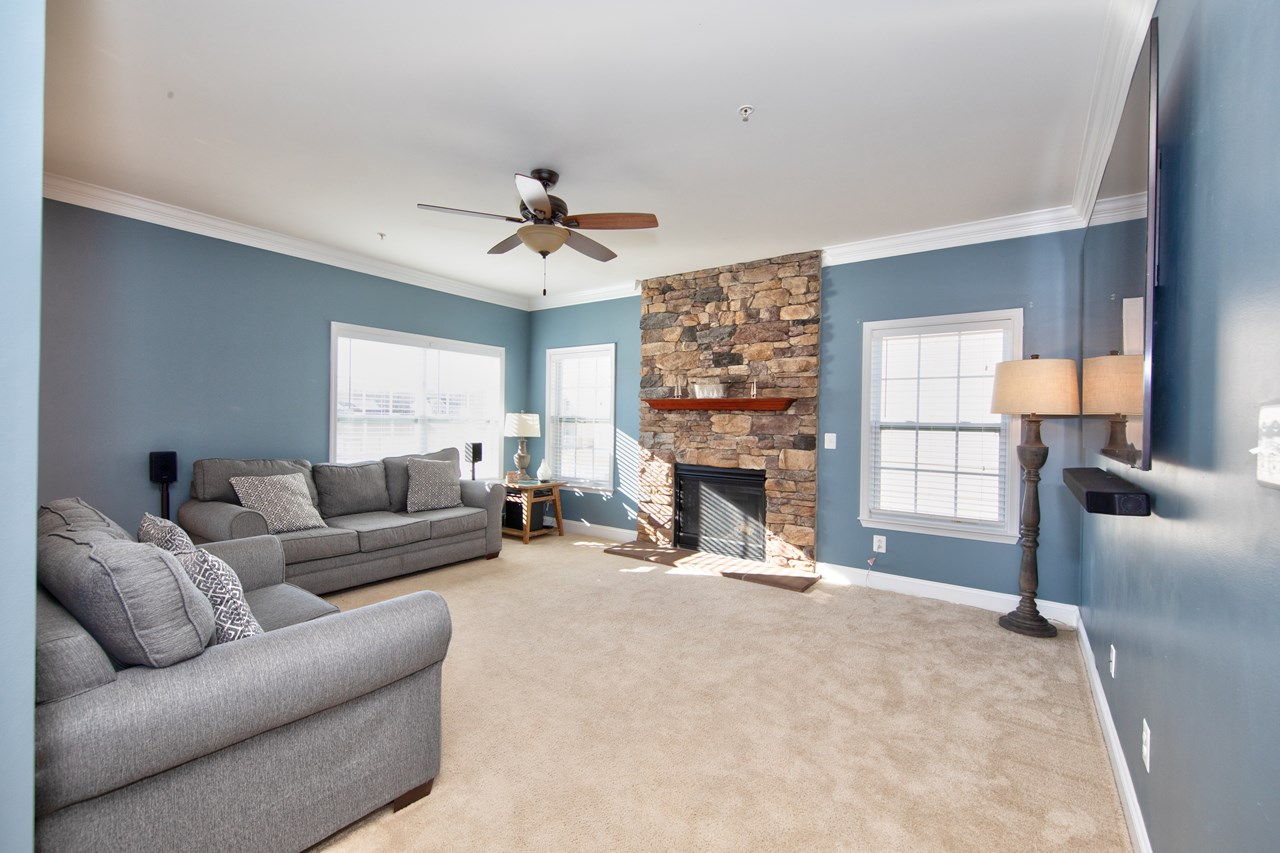 family room with stone hearth & gas fireplace