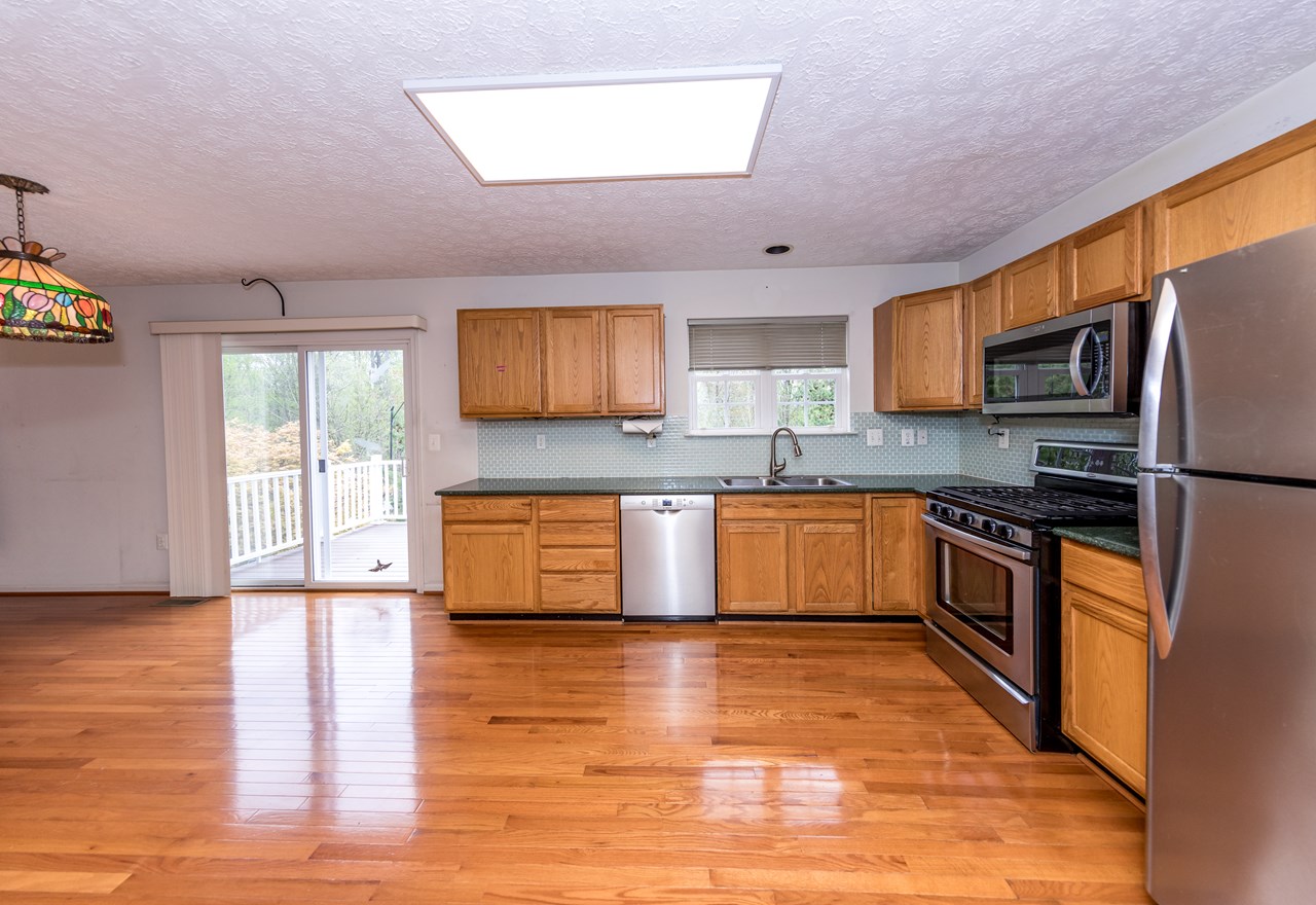 large kitchen with all appliances & deck access