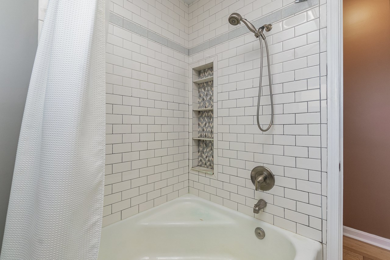 tub with tiled surround shower