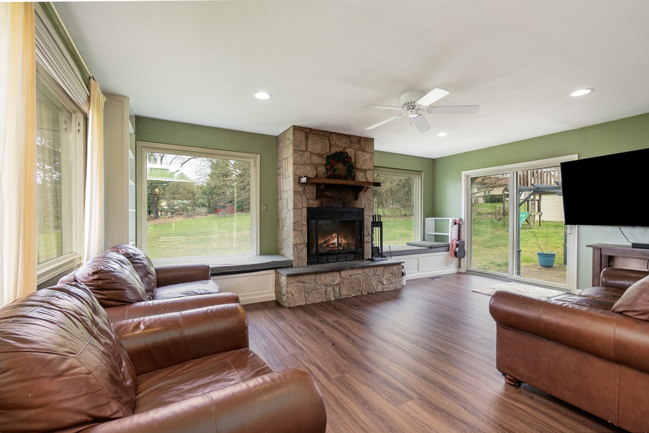 family room w/ fireplace overlooking rear yard