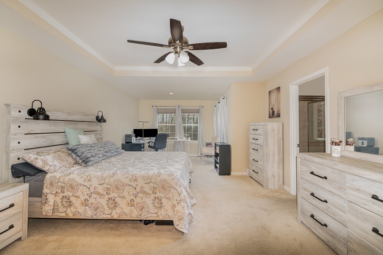primary bedroom with large walk in closet & full bathroom