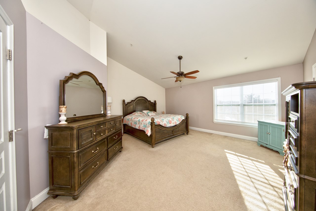 super-sized primary bedroom with vaulted ceiling