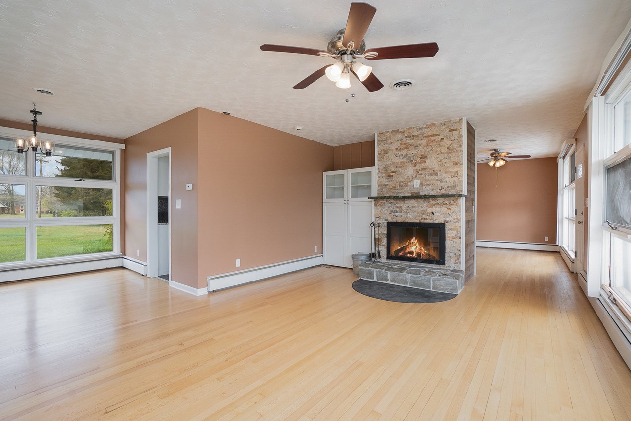 living room with wood burning fireplace
