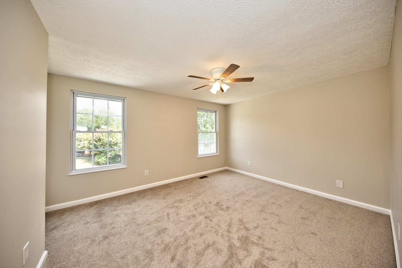 primary bedroom with ceiling fan