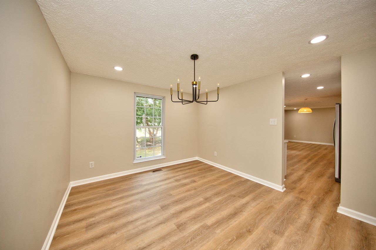 dining room with new luxury vinyl floors & chandelier