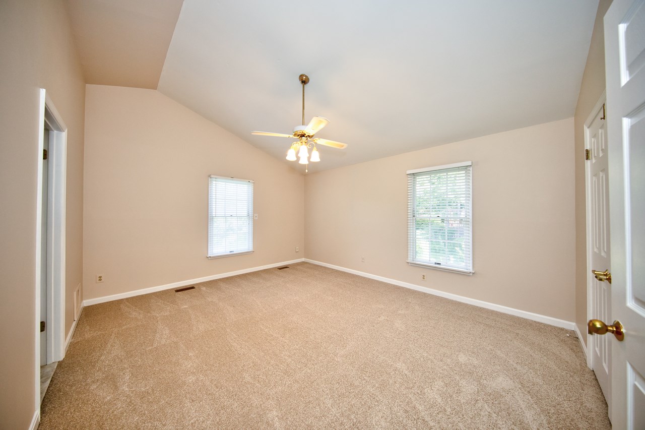 primary bedroom w/ vaulted ceiling