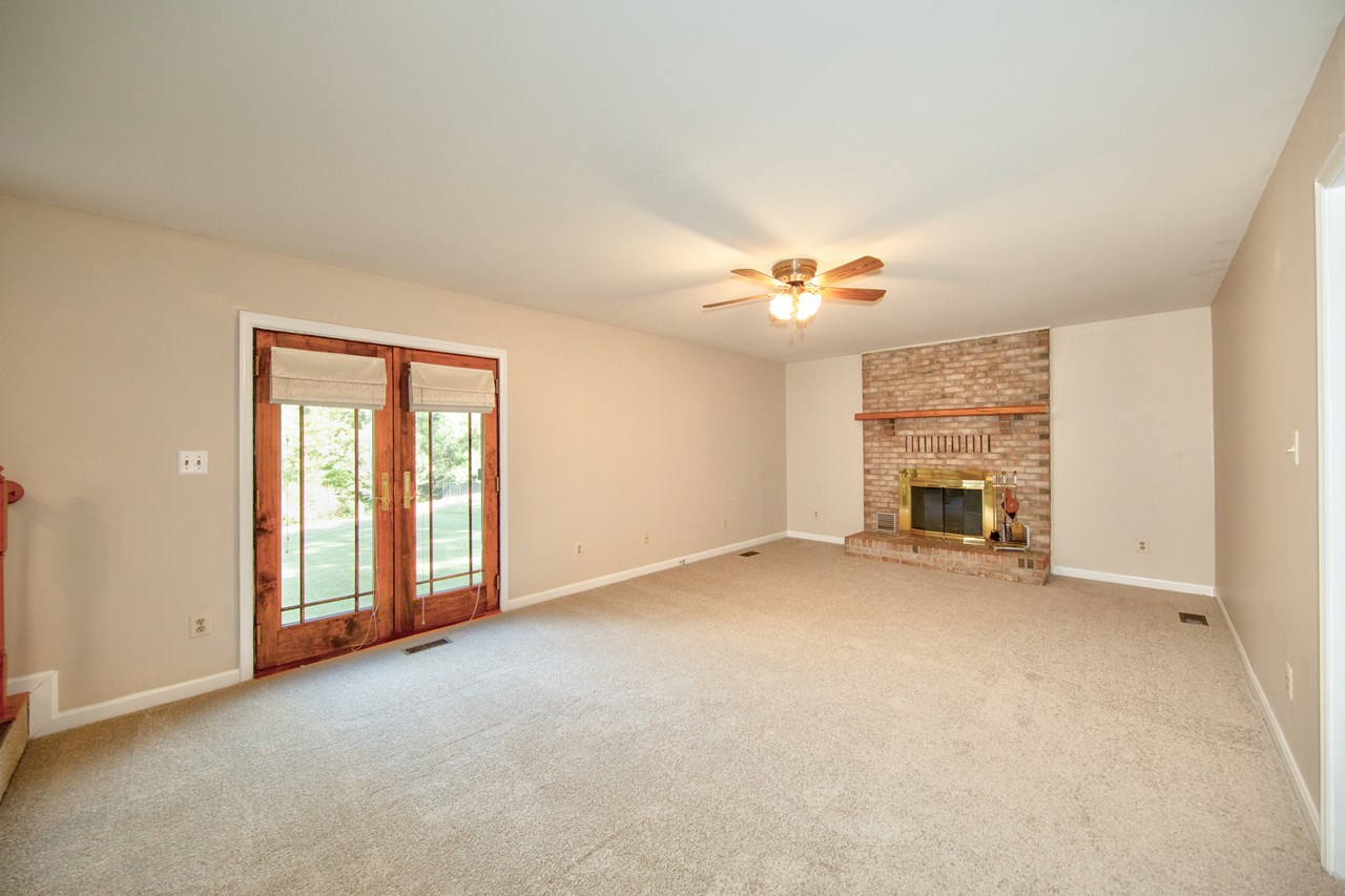 family room with fireplace, new carpet & paint