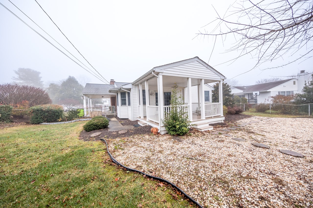 rear view of home with fenced rear yard & shed