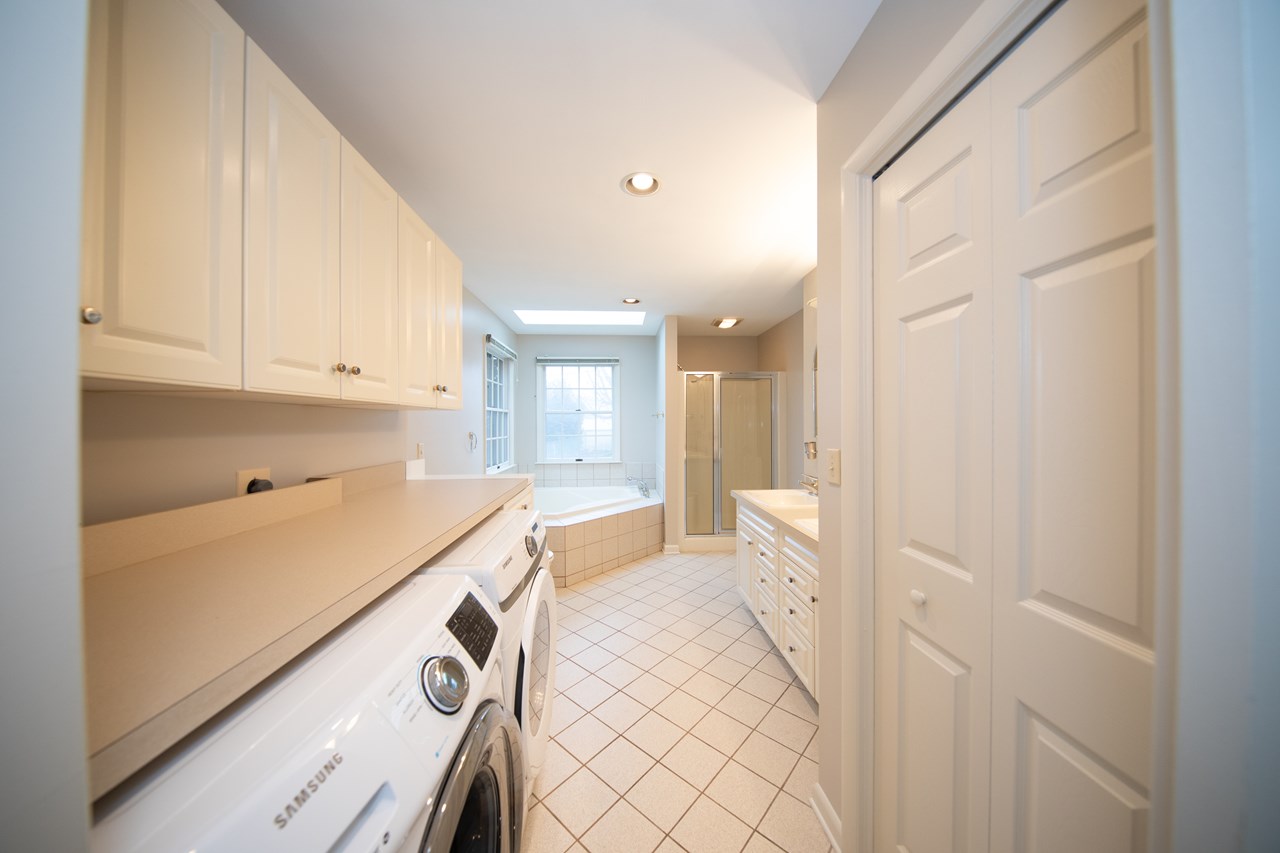 primary bathroom with soaking tub & separate shower/ main level laundry