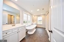 primary bathroom with soaking tub, separate shower & double sinks