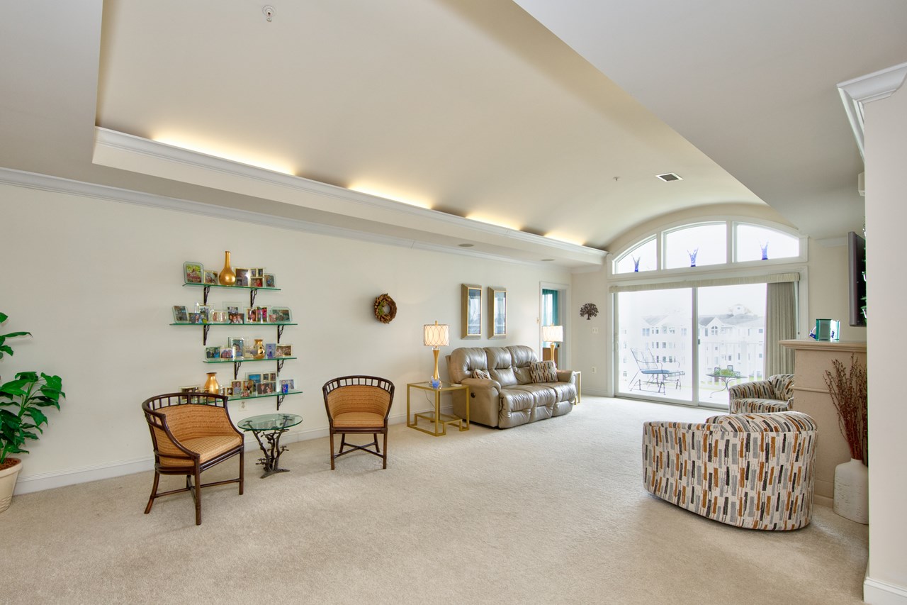 living room with coffered ceiling & balcony