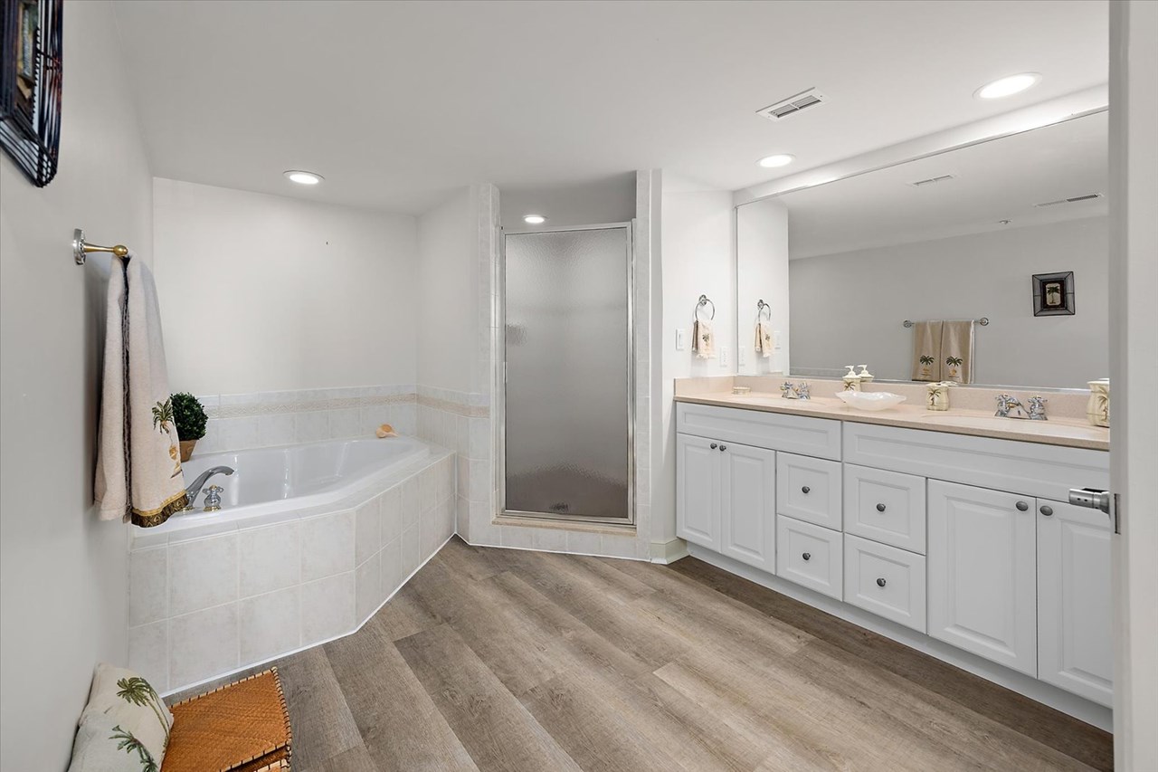 primary bathroom with dual sinks, soaking tub & sep shower