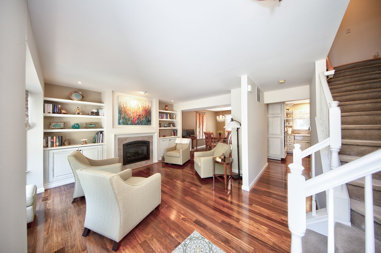 beautiful living room with bay window, fireplace & built in shelving