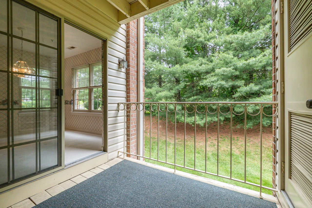 covered balcony backing to trees