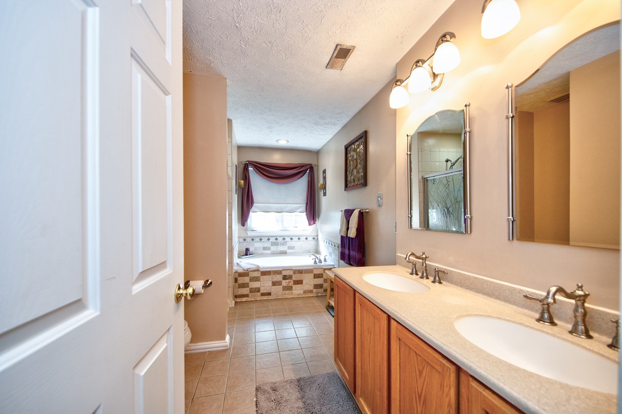 primary bathroom with double sinks, soaking tub & shower