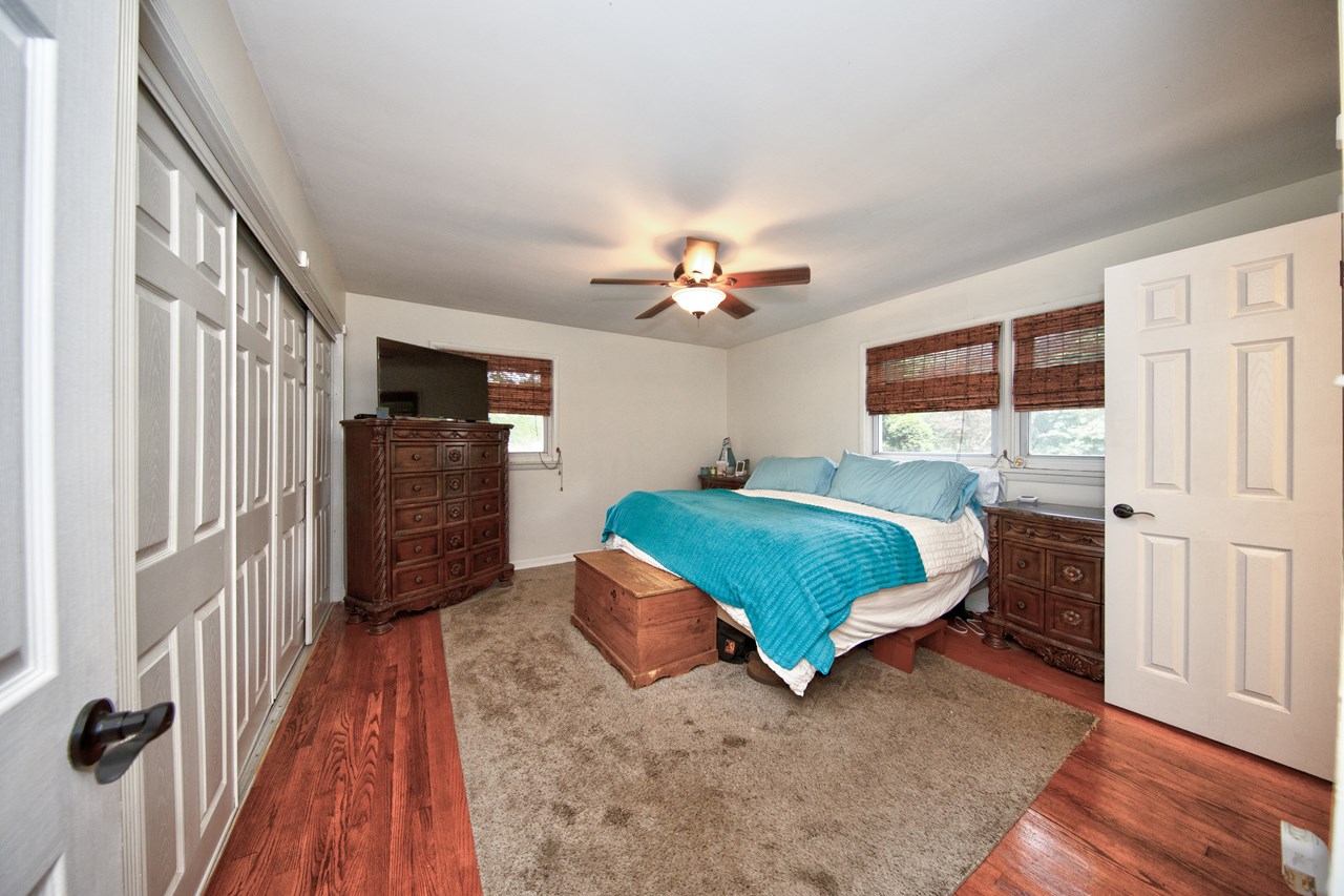 primary bedroom with large closet &ceiling fan