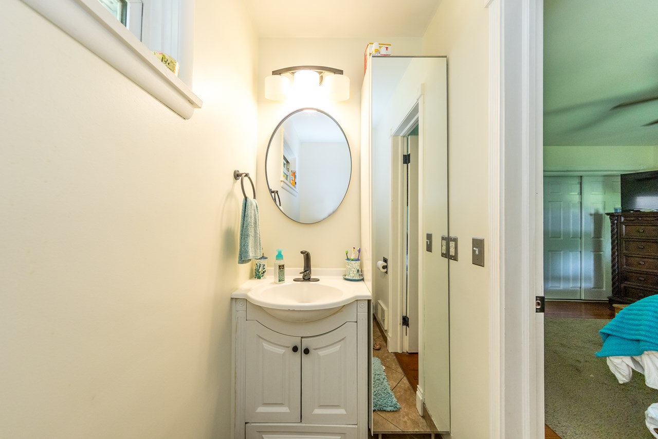 primary bedroom with half bath