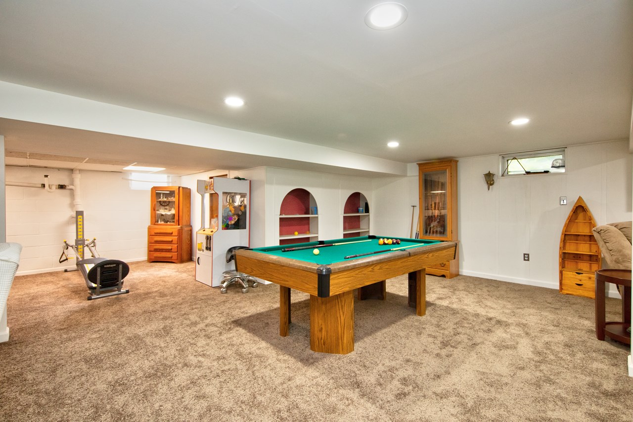 basement rec room with built in shelves