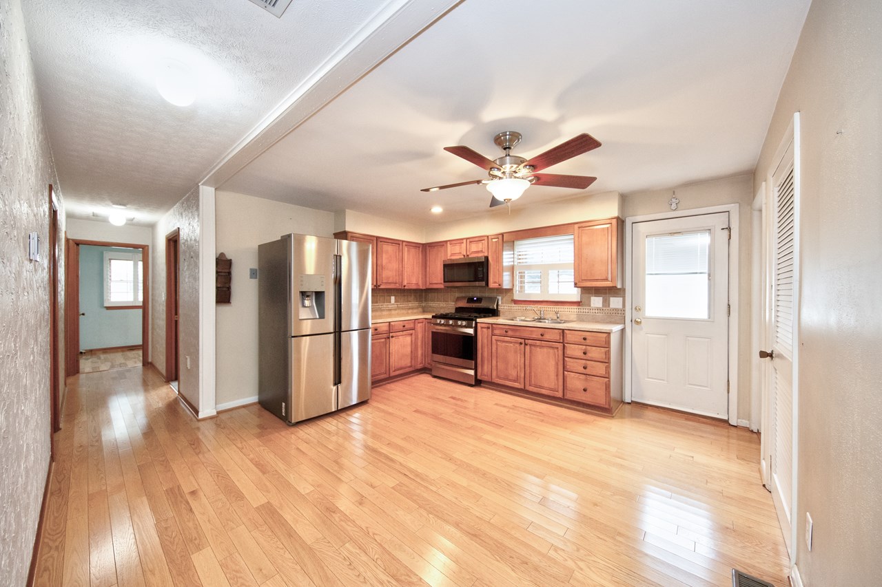 kitchen w/ gas stove & door to backyard