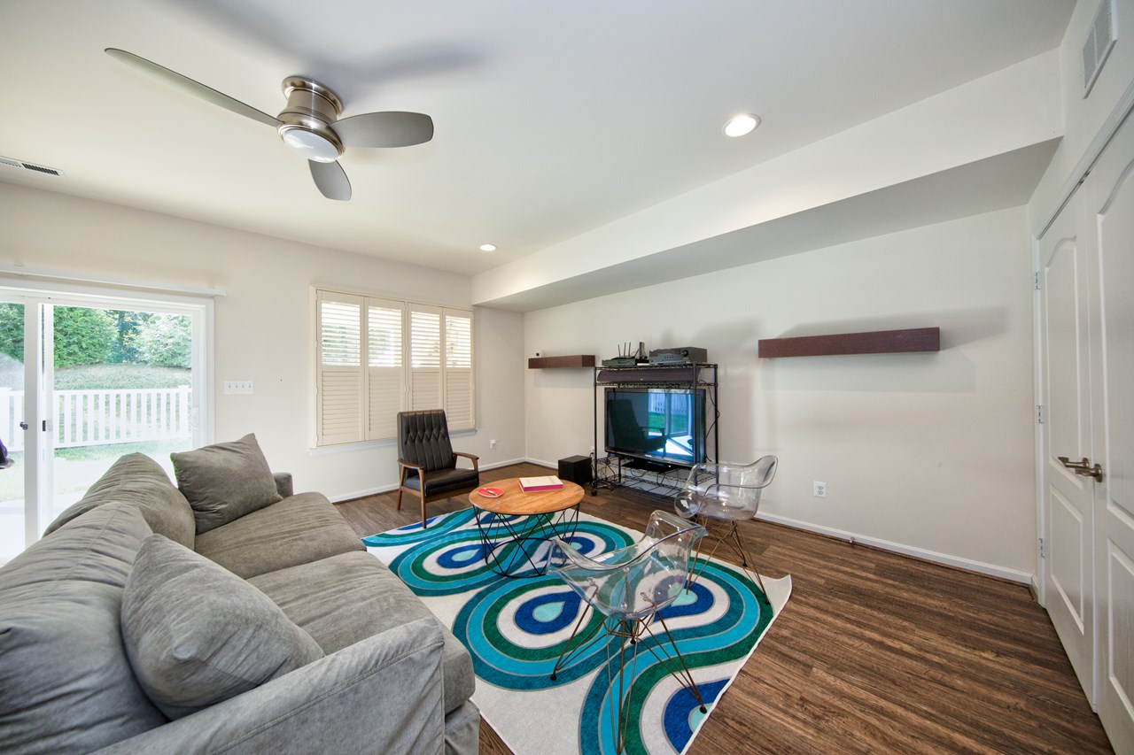 lower level family room w/ luxury floors & sliders to rear yard