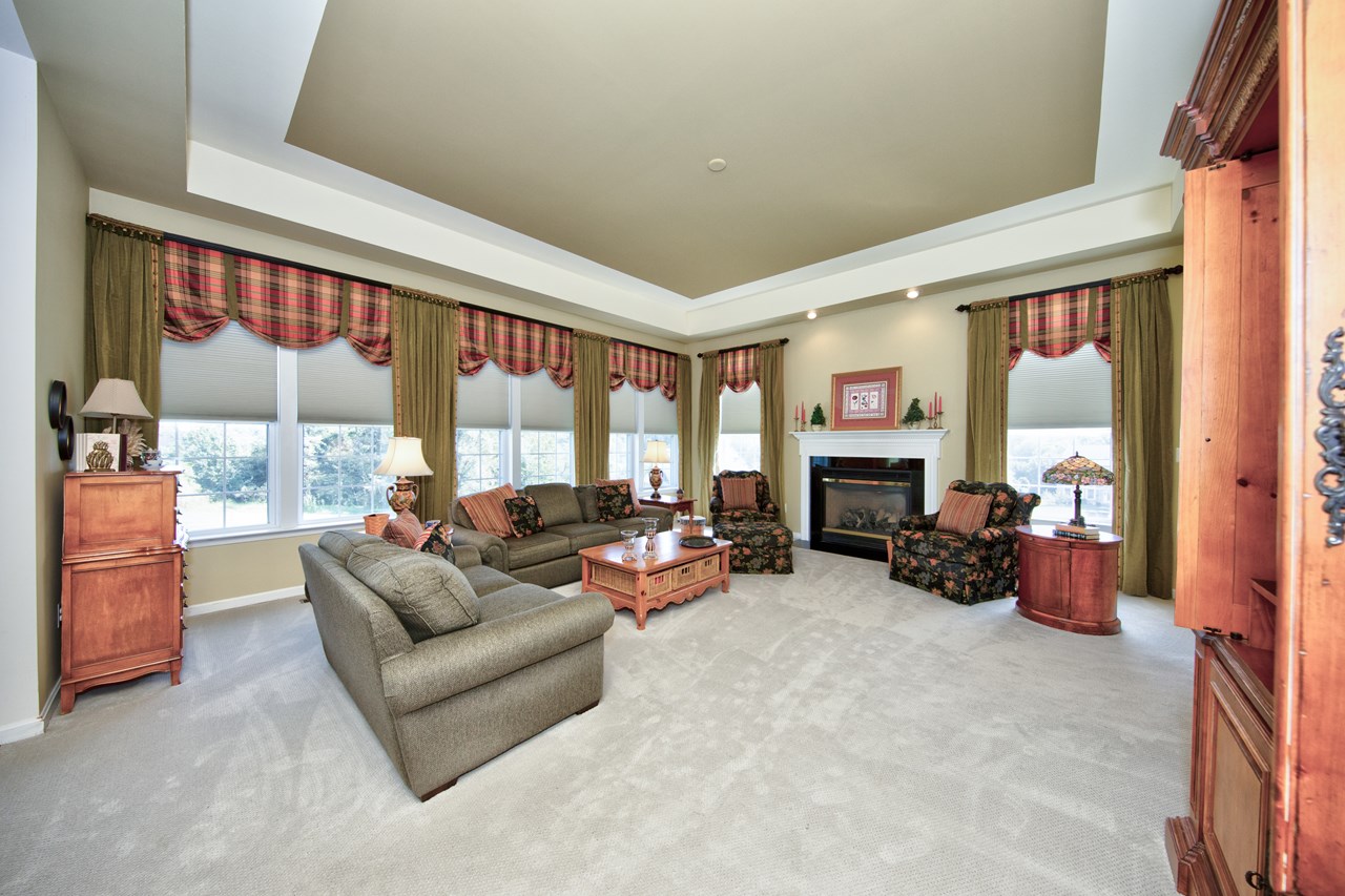 family room with gas fireplace & tray ceiling