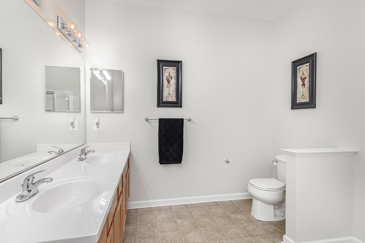 primary bathroom with double sinks, soaking tub & shower