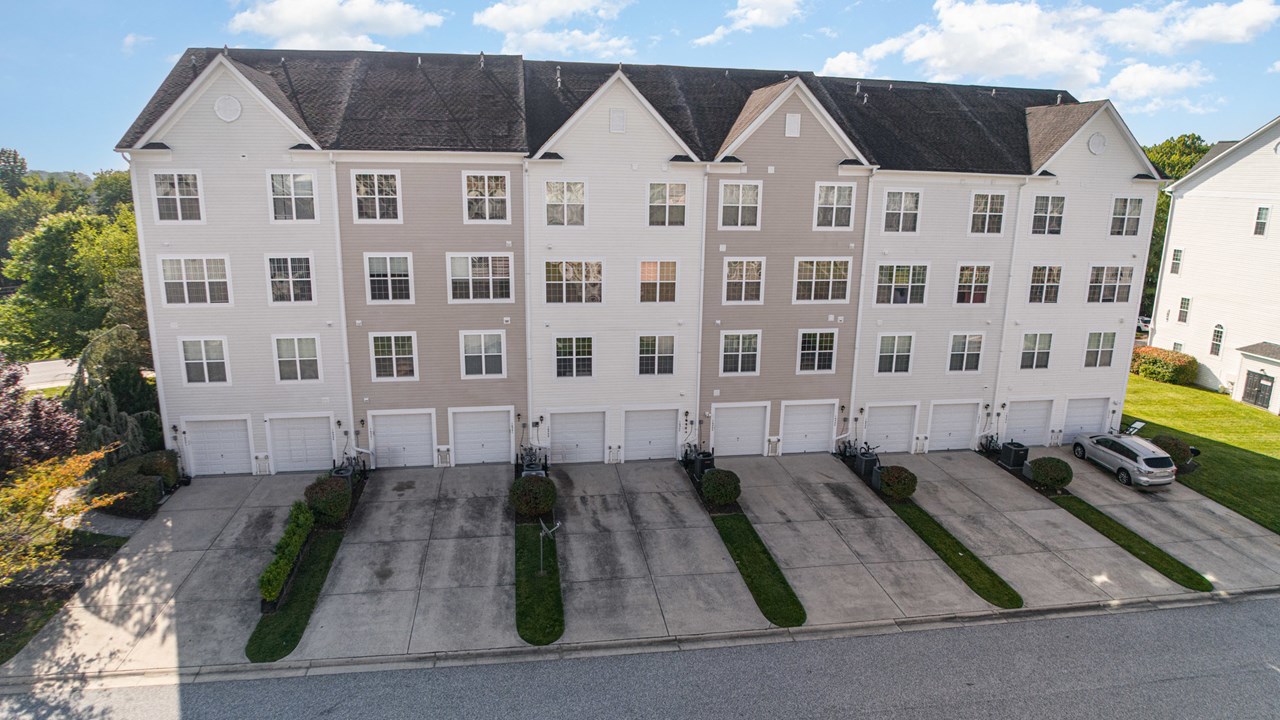 rear view with 1 car garage & parking