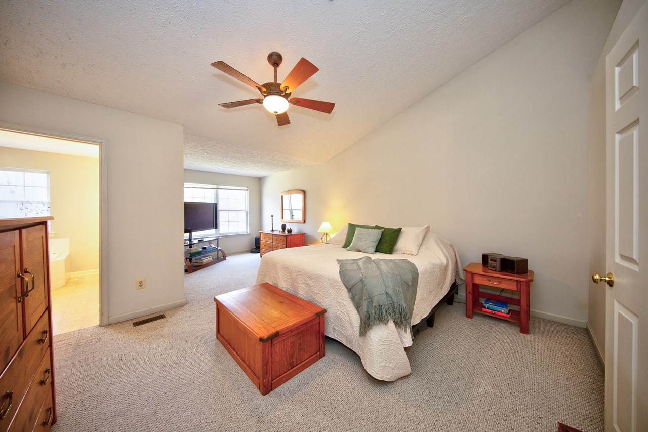 primary bedroom with ceiling fan