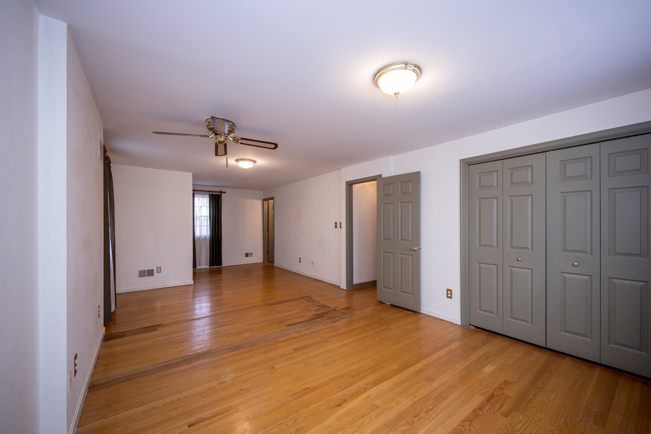 primary bedroom with ceiling fan & 2 large closets