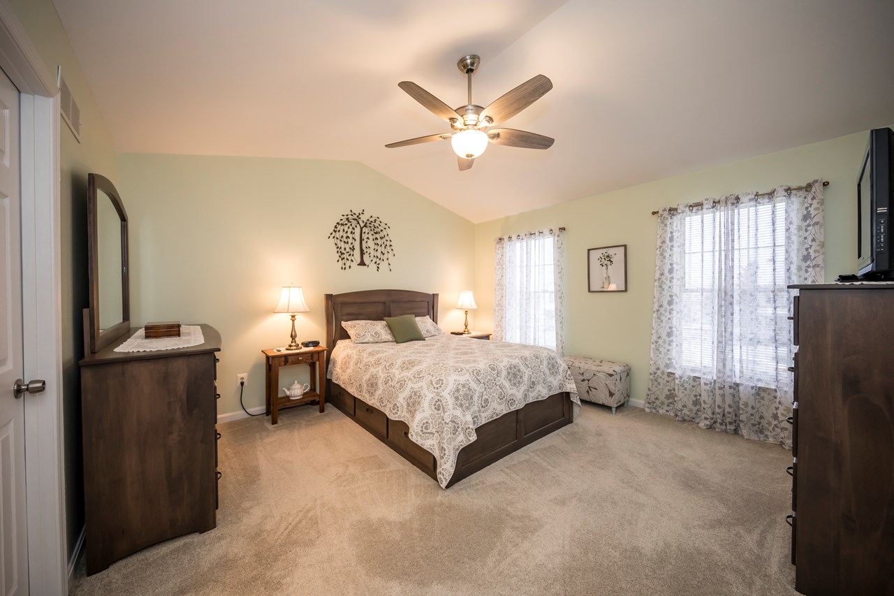 primary bedroom with vaulted ceiling & walk in closet