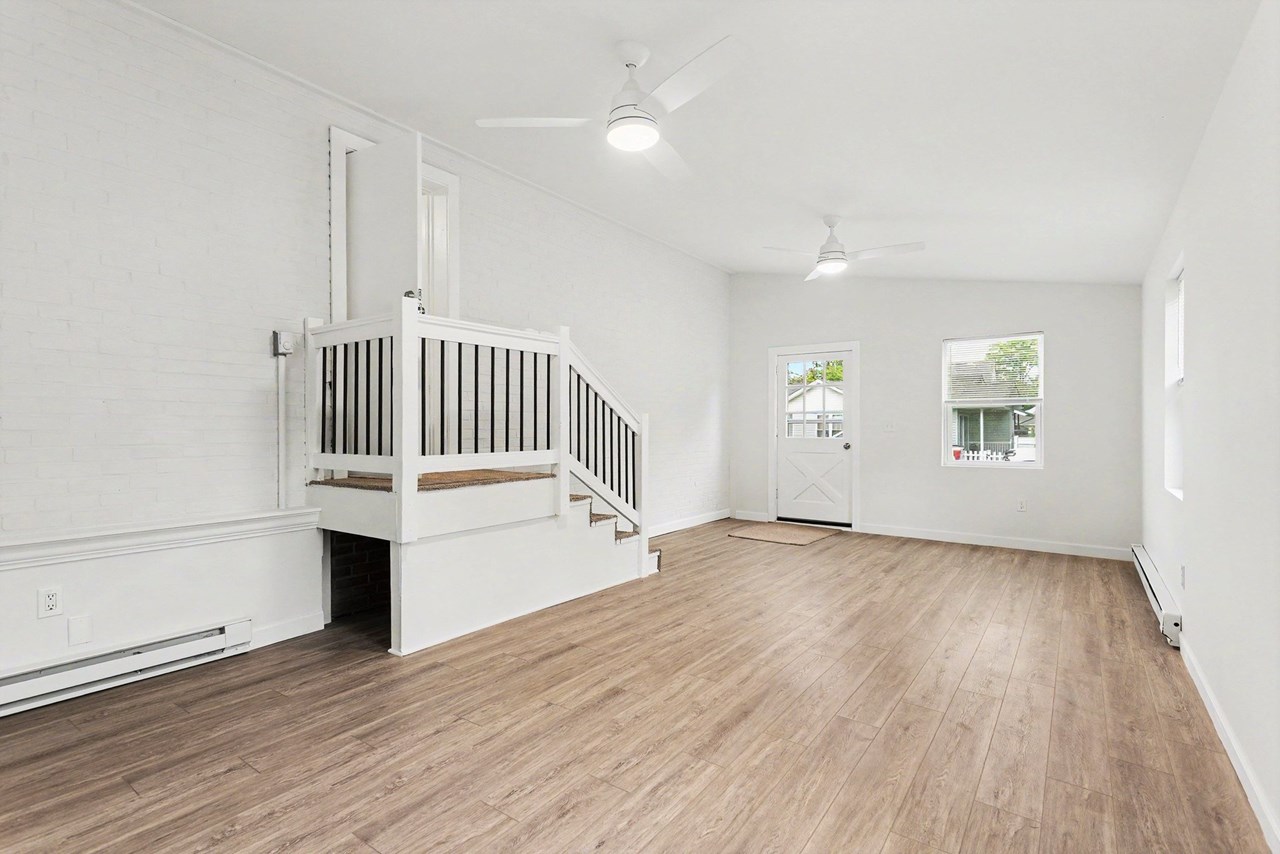 family room with new floors, windows & ceiling fans