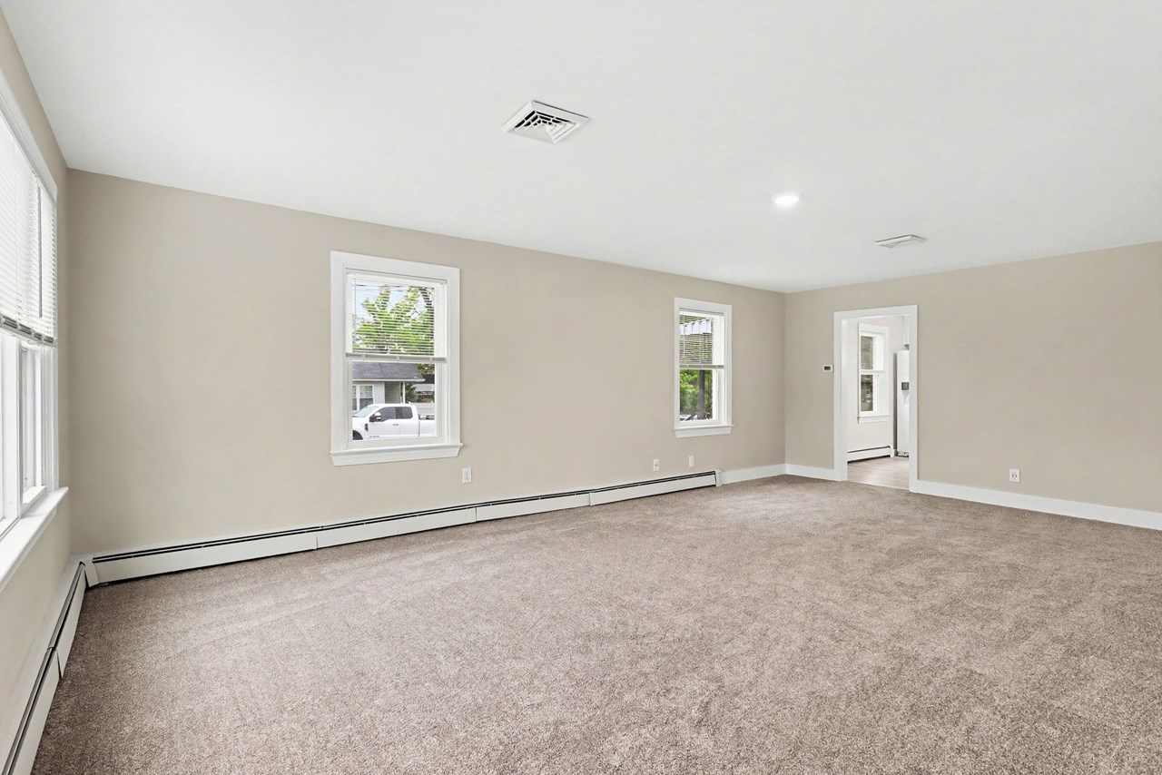 large living room with new carpet & fresh paint