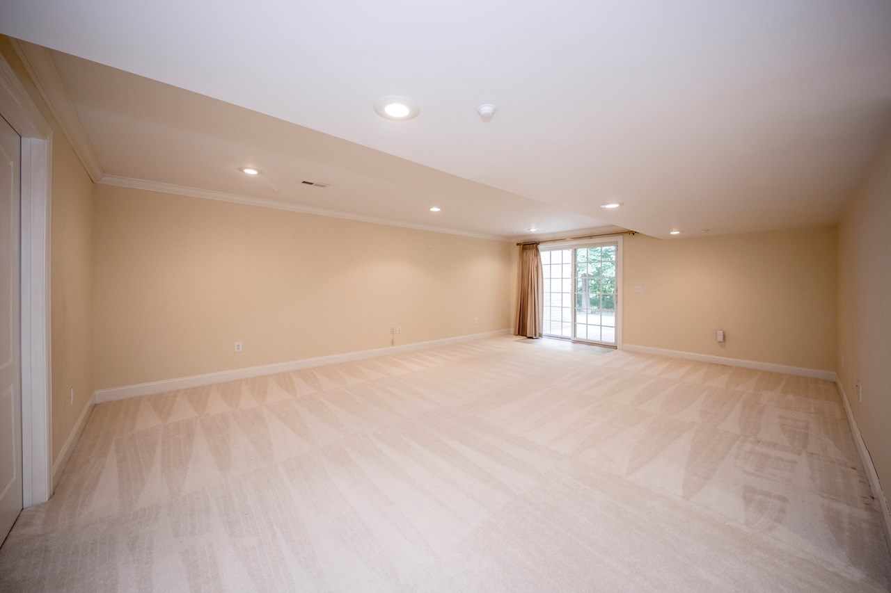 finished family room with sliders to patio