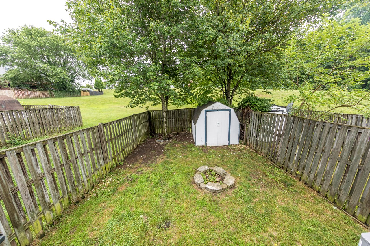 fenced rear yard with as-is shed