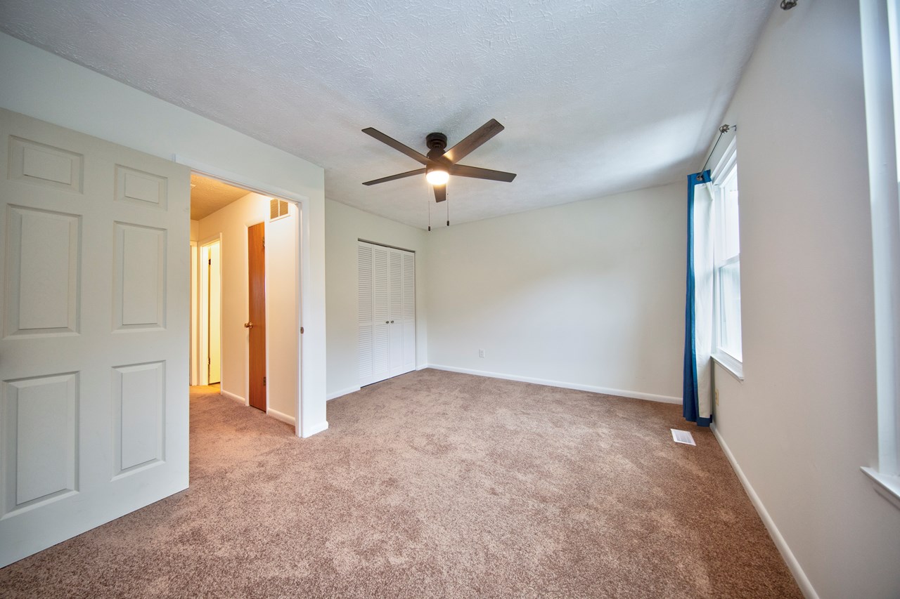primary bedroom with new carpet, paint & windows