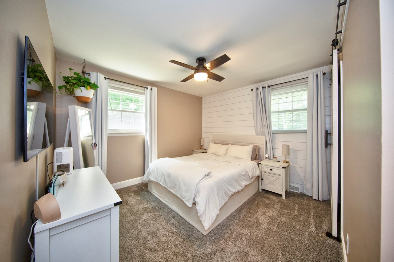 primary bedroom w/ shiplap wall