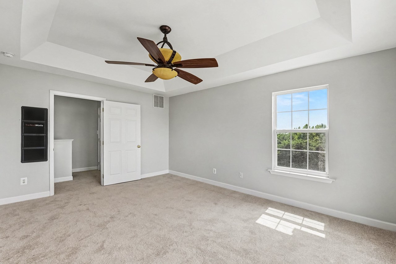 primary bedroom with tray ceiling