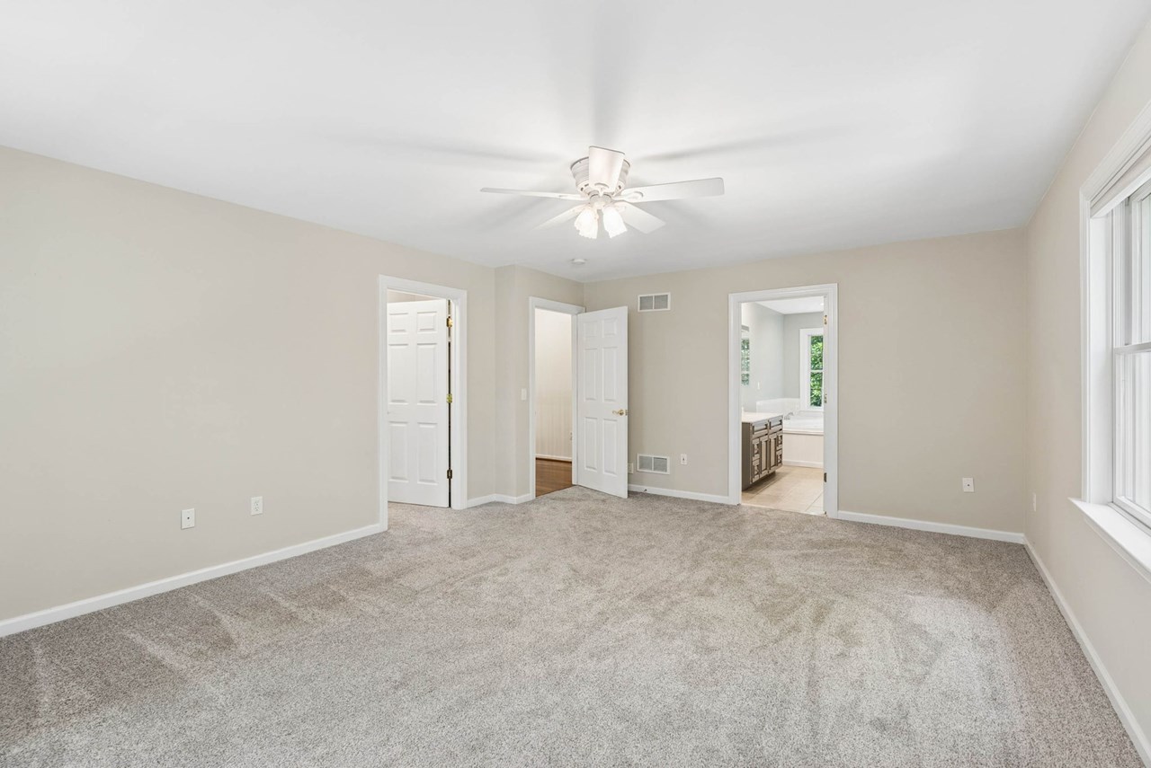 primary bedroom with walk in closet & bath