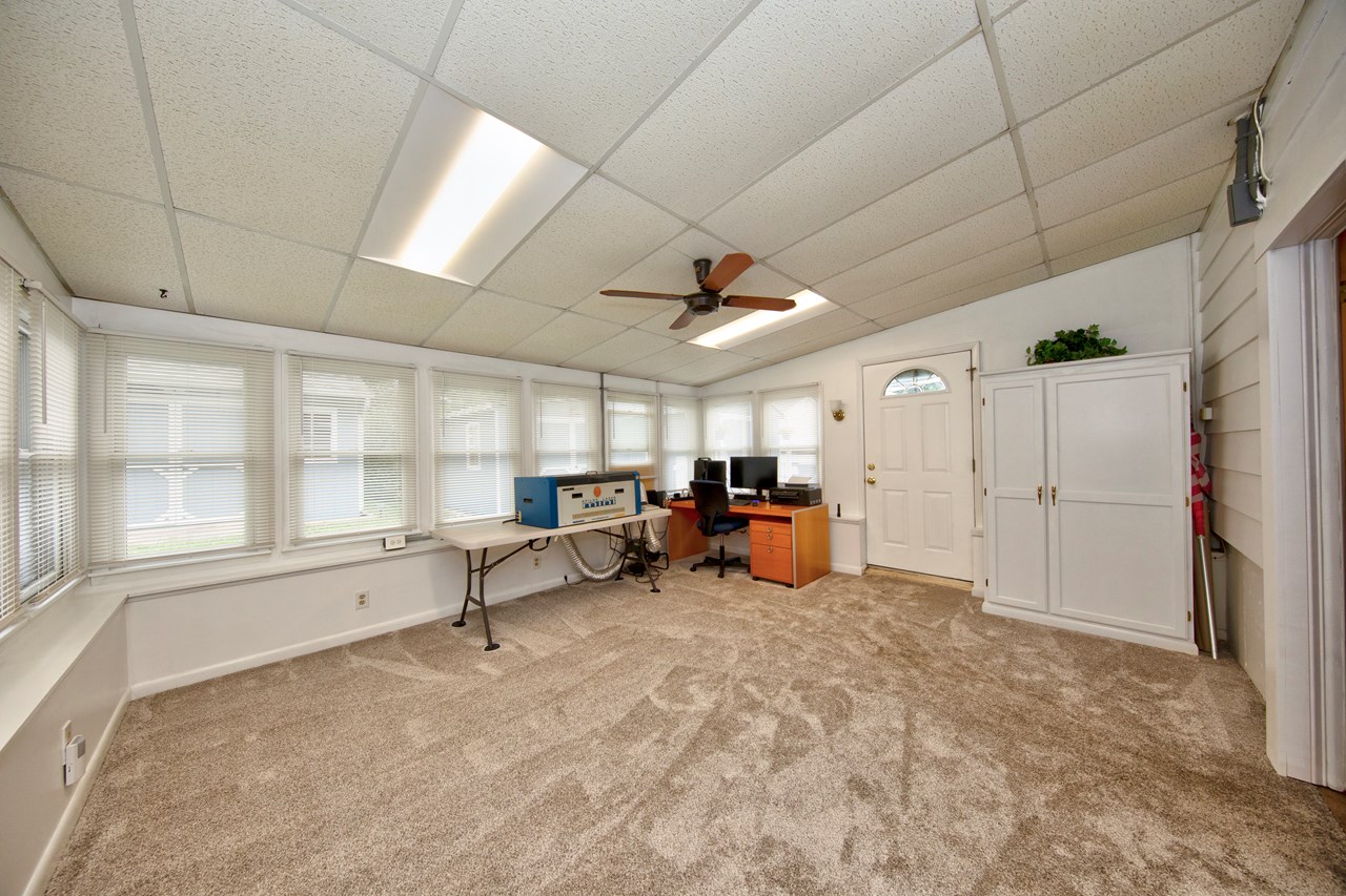 sunroom/ den with new carpet & walk out to rear yard