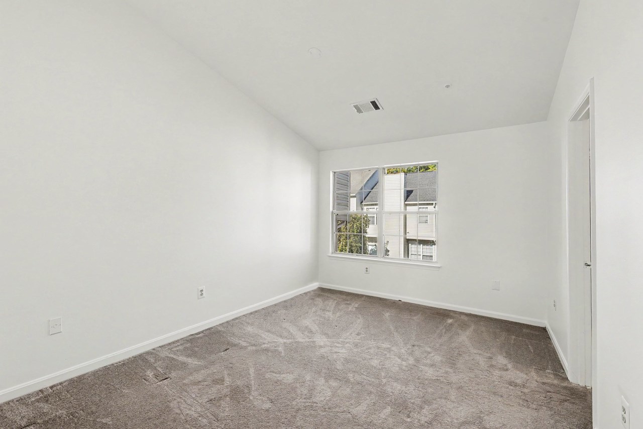 primary bedroom with vaulted ceiling